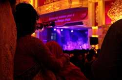 A Woman enjoying cultural program at Durga Puja
