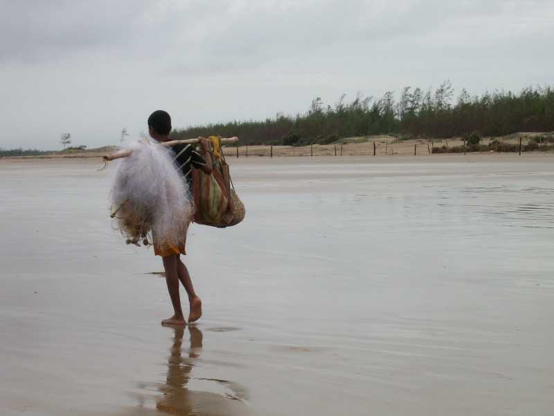 A Fisherboy Sauntering Along The Beach…