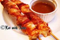 Bacon wrapped prawn with prawn head reduction sauce