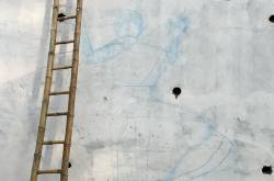 The rickety ladders and working on the wall.