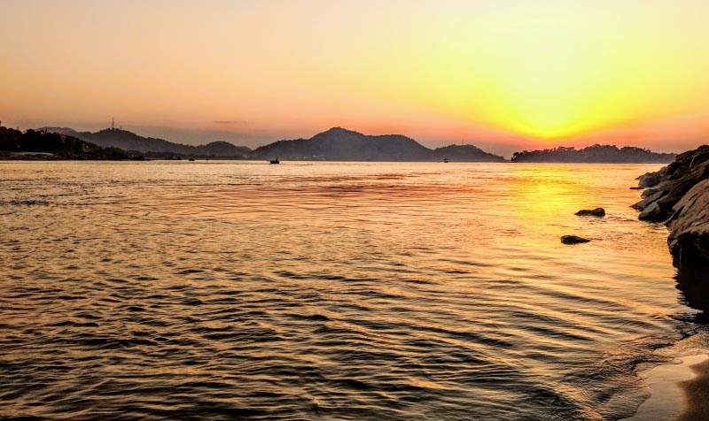Umananda Temple And A Sunset Over The Brahmaputra River - Shoe Bytes
